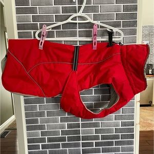 Dog coat for larger dogs, with integrated harness. Red black trim